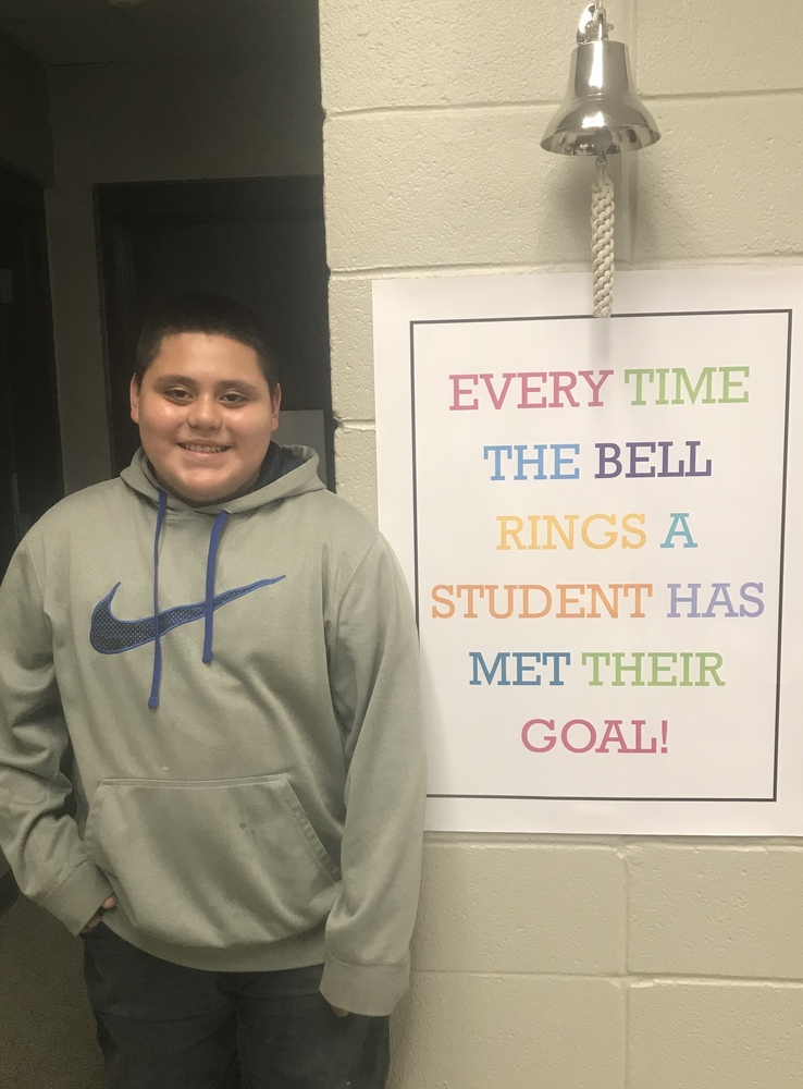 Student standing by bell