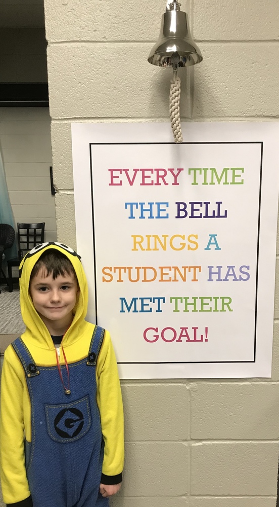 Student standing by bell