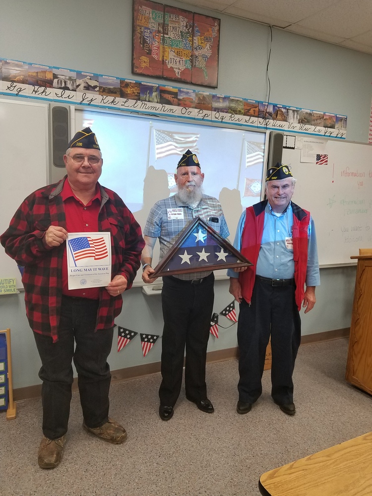 Veterans presenting an American flag