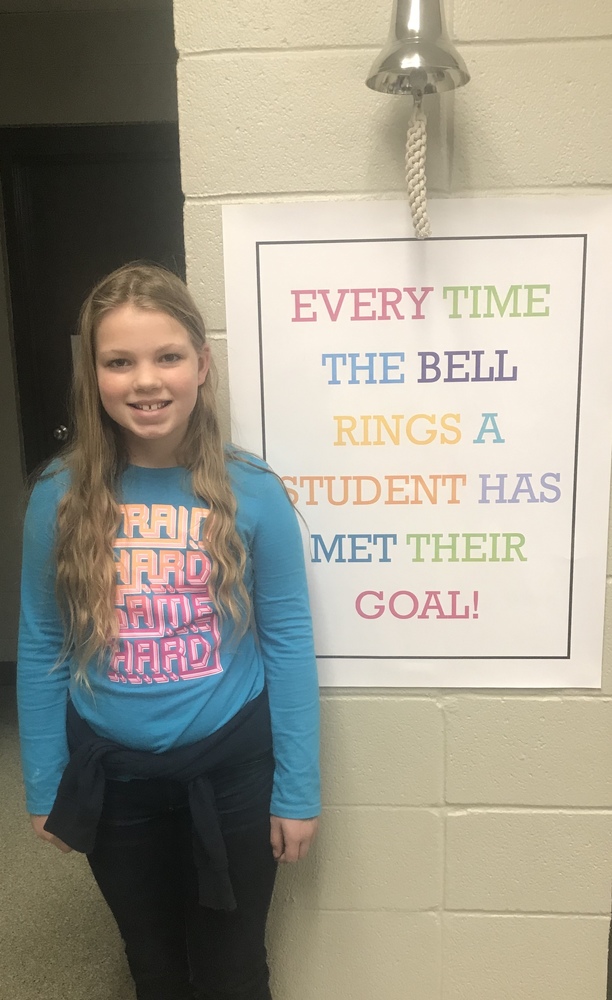 Student standing by bell