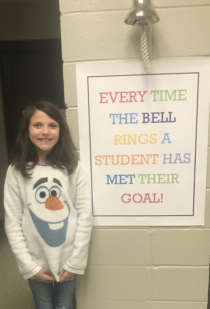 Student standing by bell